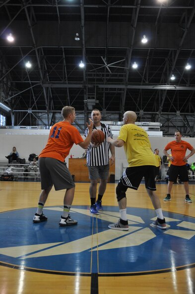 Airmen from the 445th Logistics Readiness Squadron and 445th Aeromedical Evacuation Squadron start the play of the second game of  the March Mania Basketball Tournament. The LRS ultimately walked away as champions of the event, having played in, and won, three out of the four games. (U.S. Air Force photo/Staff Sgt. Rachel Ingram)