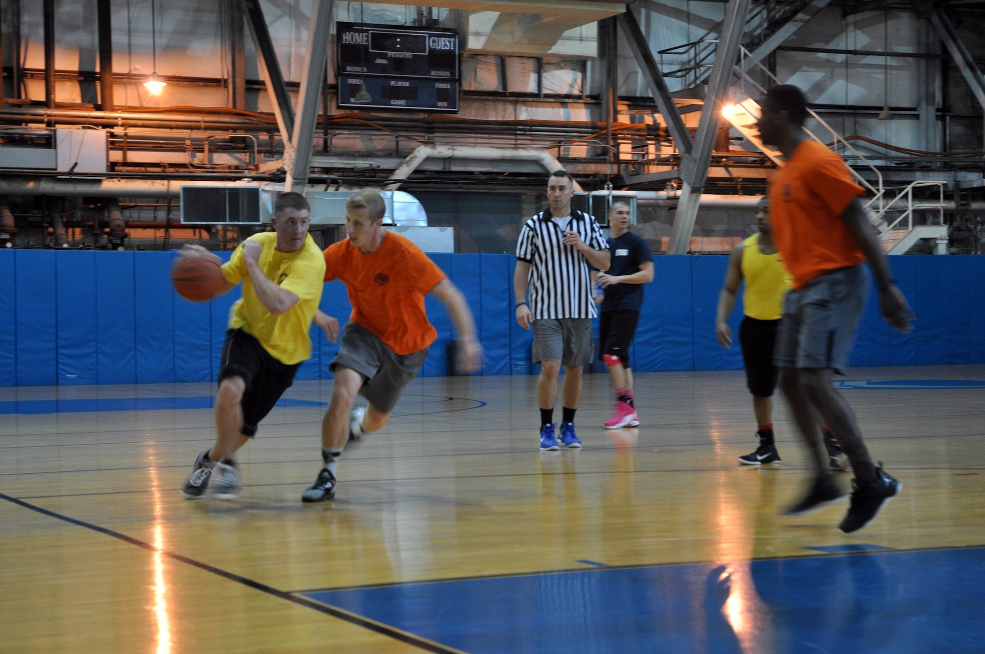 Airmen from the 445th Aeromedical Evacuation Squadron and 445th Logistics Readiness Squadron race to the basket during the second game of the March Mania Basketball Tournament. The LRS ultimately walked away as champions of the event, having played in, and won, three out of the four games. (U.S. Air Force photo/Staff Sgt. Rachel Ingram)