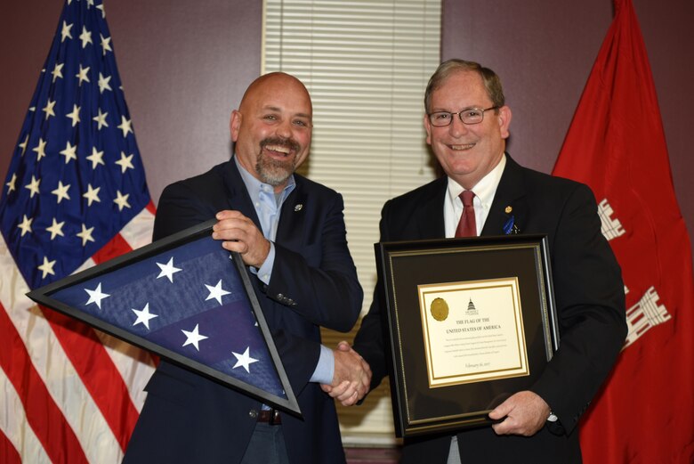 David Bowling (Left), Tennessee Valley Authority vice president of River and Land Operations, presents Mike Wilson with a U.S. Flag flown over the U.S. Capitol Building in Washington D.C., at the request of Congressman John J. Duncan, Jr., 2nd District of Tennessee.  Wilson, U.S. Army Corps of Engineers Nashville District deputy for Programs and Project Management, culminated 42 years of federal service during a ceremony at the district headquarters in Nashville, Tenn., March 31, 2017. 