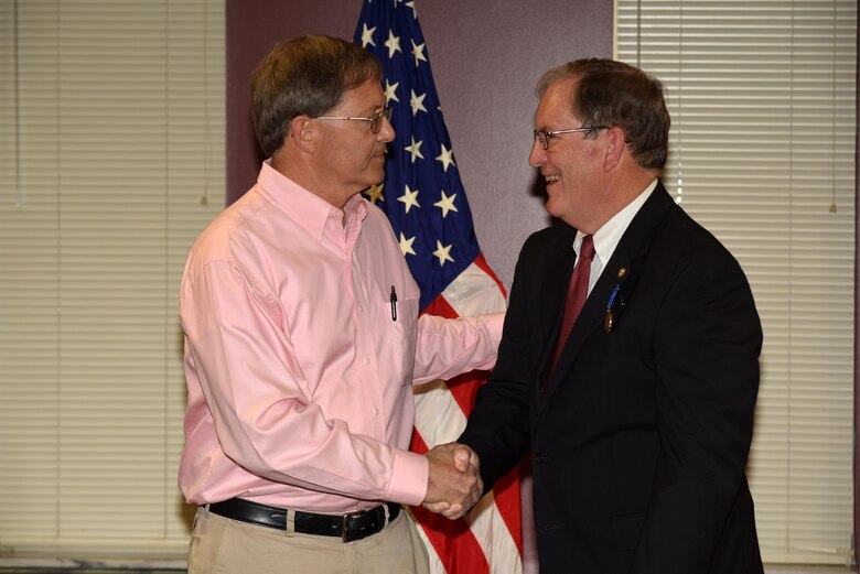 Walter Green (Left), friend, former project manager and retiree, congratulates Mike Wilson, U.S. Army Corps of Engineers Nashville District deputy for Programs and Project Management, during a retirement ceremony at the district headquarters in Nashville, Tenn., March 31, 2017.