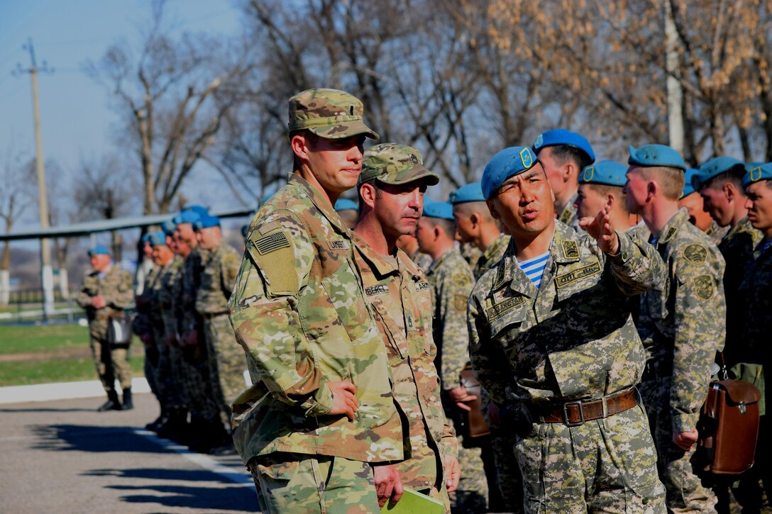 U.S. Army Soldiers discuss the schedule for Steppe Eagle Koktem with a Kazakhstani soldier after the opening ceremony Mar. 31, 2017.