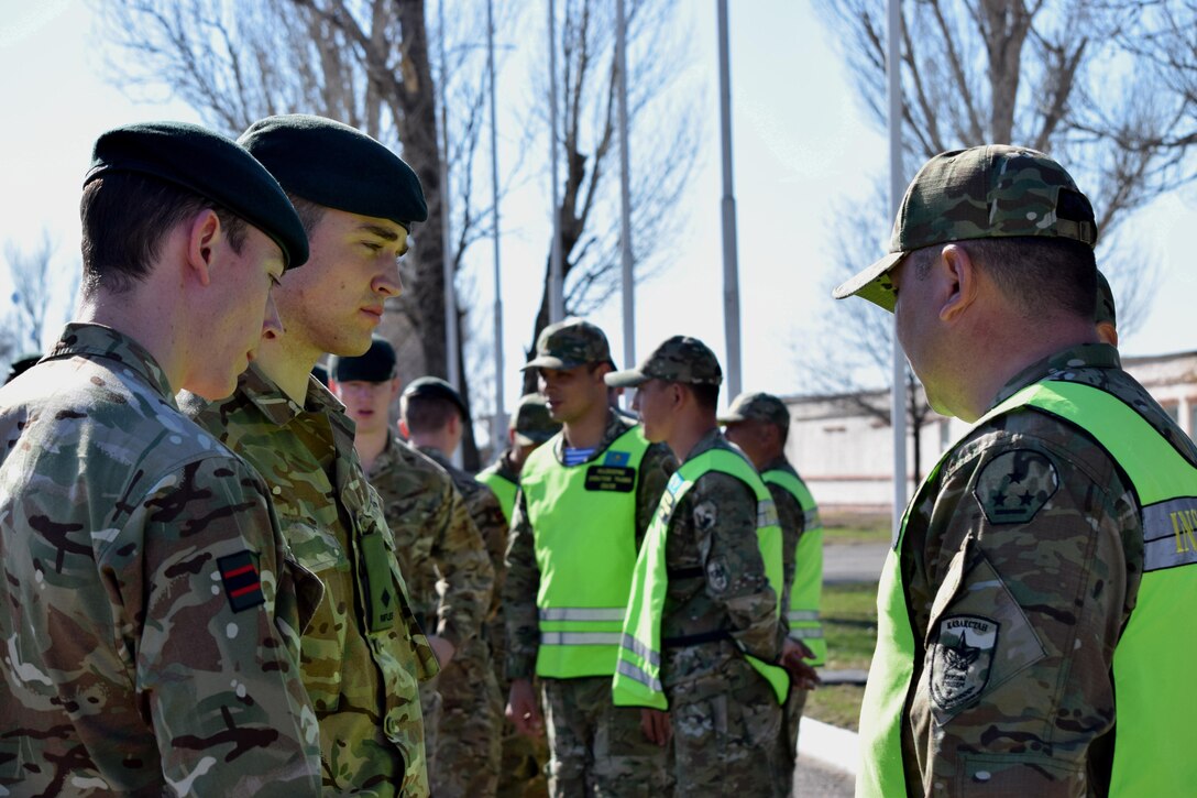 U.K. soldiers from 1st Battalion, The Rifles, 160 Brigade, meet with instructors from the Kazakhstan Peacekeeping Battalion after the opening ceremony of Koktem, the first phase of Exercise Steppe Eagle, Mar. 31, 2017.
