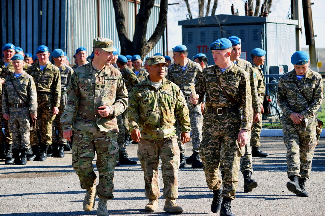 U.S. Army Soldiers discuss the schedule for Steppe Eagle Koktem with a Kazakhstani soldier after the opening ceremony Mar. 31, 2017.