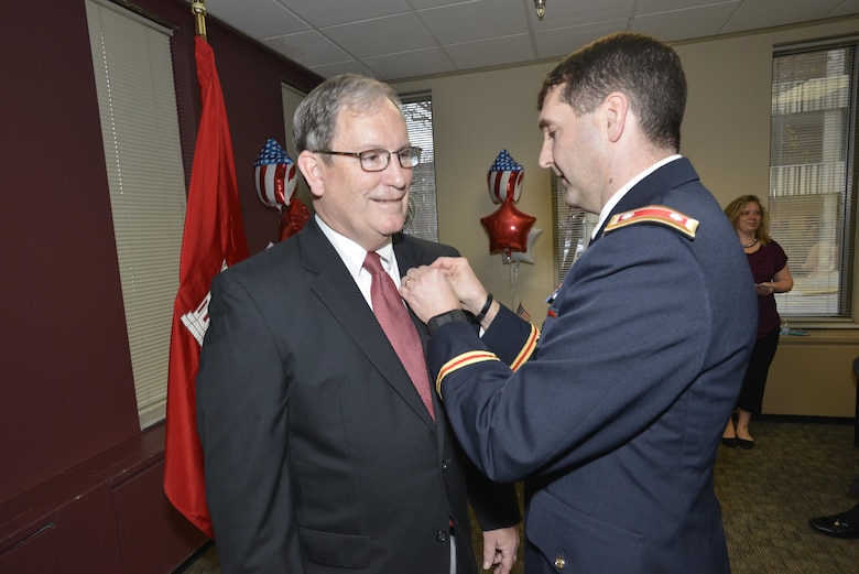 Lt. Col. Stephen Murphy, U.S. Army Corps of Engineers Nashville District commander, awards the Department of the Army Meritorious Civilian Service Award for his distinguished service to the nation during 42 years of federal service to Mike Wilson, Nashville District deputy district engineer for Project Management, during his retirement ceremony at the district headquarters in Nashville, Tenn., March 31, 2017. (USACE photo by Mark Rankin)