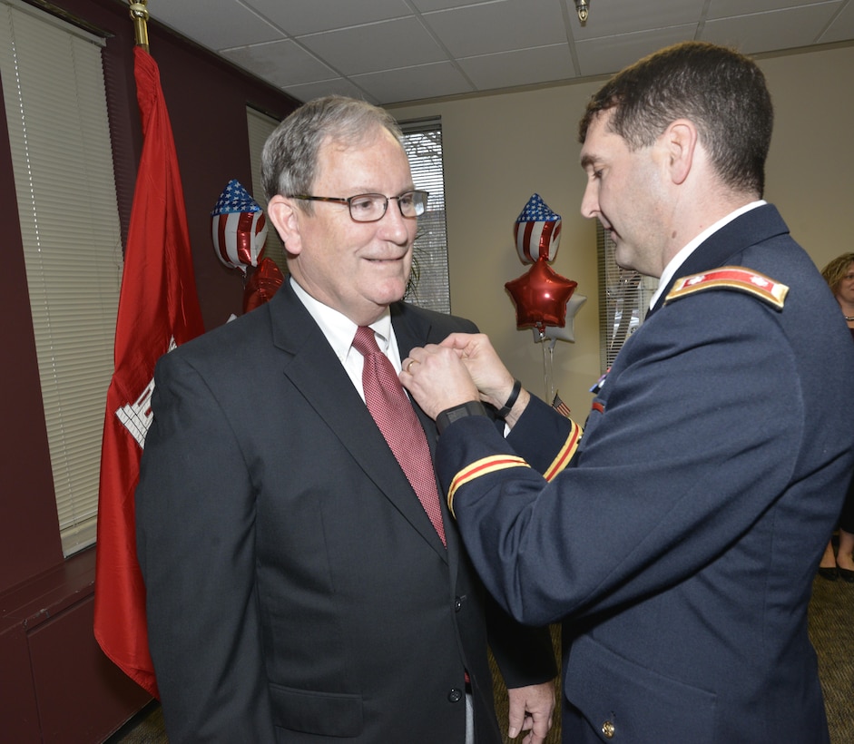 Lt. Col. Stephen Murphy, U.S. Army Corps of Engineers Nashville District commander, awards the Department of the Army Meritorious Civilian Service Award for his distinguished service to the nation during 42 years of federal service to Mike Wilson, Nashville District deputy district engineer for Project Management, during his retirement ceremony at the district headquarters in Nashville, Tenn., March 31, 2017. 