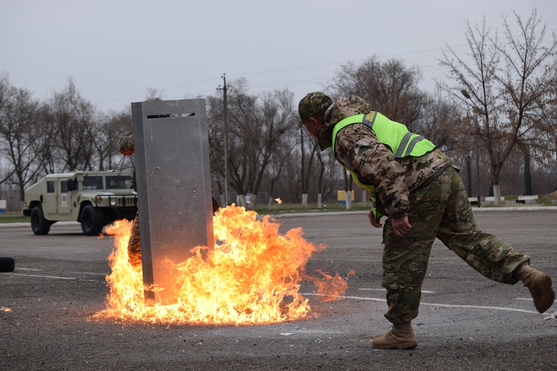 A Kazakhstani instructor for the Kazakhstan Peacekeeping Battalion demonstrates how to react to a petrol bomb when conducting crowd control operations Apr. 1, 2017, during phase one of Exercise Steppe Eagle at Illisky Training Center, Kazakhstan.