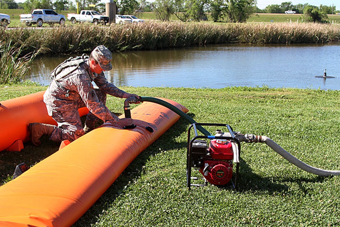 Louisiana Army National Guard Sgt. Christopher Storer learns how to deflate the Tiger Dam flood control system during a disaster response exercise in St. Charles Parish, Louisiana, April 1, 2017. Storer is a heavy equipment operator assigned to the Louisiana Army National Guard’s 2225th Multi-Role Bridge Company, 225th Engineer Brigade. The exercise provides National Guard units with the opportunity to improve on cooperation and relationships with not only local and state agencies, but also military and federal partners for emergencies and catastrophic events. Army National Guard photo by Sgt. Renee Seruntine