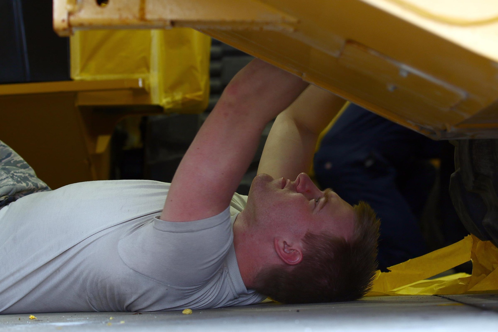 Senior Airman Gage Brunswick, 445th Logistics Readiness Squadron, tapes up a track loader in preparation to be painted while performing his annual tour here March 13, 2017. The paint is used as corrosion control due to the regions humid weather. (U.S. Air Force photo/Tech. Sgt. Patrick O’Reilly)