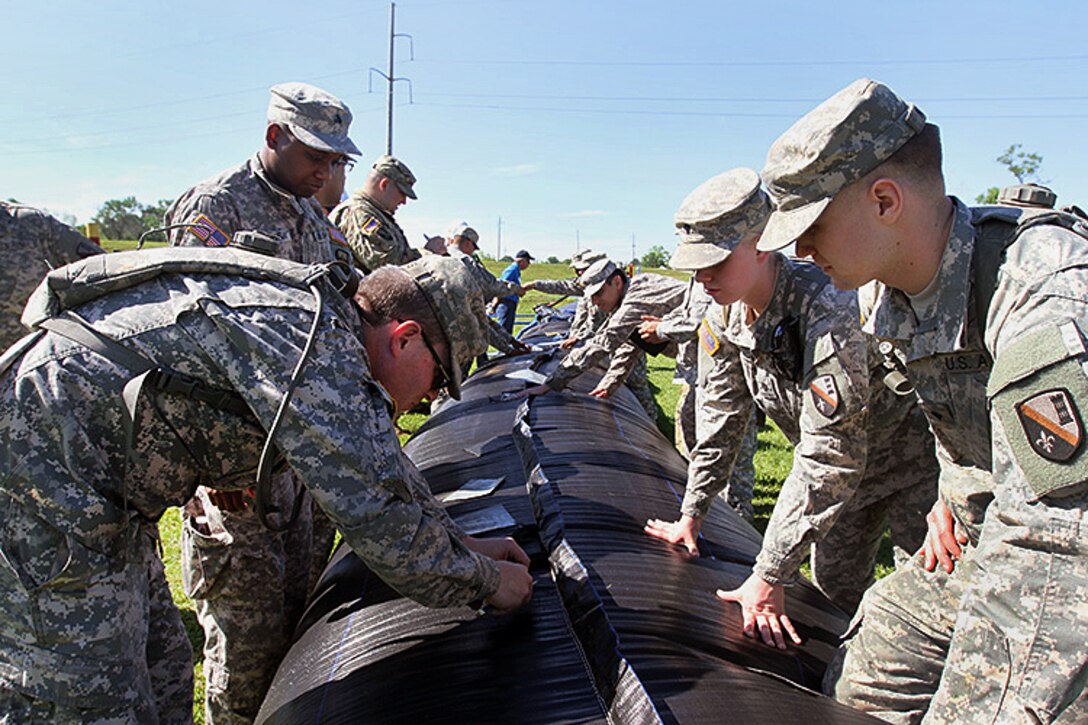 Louisiana National Guardsmen participate in patch training on the Aqua Dam system during a disaster relief exercise at the Bonnet Carre Spillway, St. Charles Parish, Louisiana, April 1, 2017. The soldiers are assigned to the Louisiana Army National Guard’s 2225th Multi-Role Bridge Company, 225th Engineer Brigade. Army National Guard photo by Spc. Cody Wolfgang Kellum 