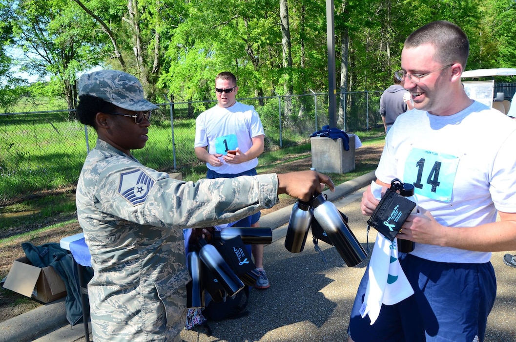 L- R MSgt. Tangela Shelton, 172d Maintenance Operation Flight distribute Sexual Assault Prevention and Response items to SRA Brady Goolsby, 183d Aeromedical Evacuation Squadron after taking physical fitness test at Thompson Field, Jackson, Miss., April 1, 2017. April is recognized as Sexual Assault Awareness and Prevention Month (SAAPM). (Air National Guard photo by MSgt. Marvin B. Moore/Released)