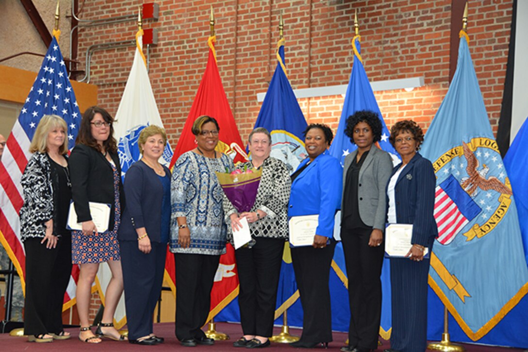 Defense Logistics Agency Finance Richmond Director Barbara Donegan (center) poses with staff members and DLA Finance Richmond Pathways to Career Excellence Program graduates during a graduation ceremony March 30, 2017 on Defense Supply Center Richmond, Virginia. 