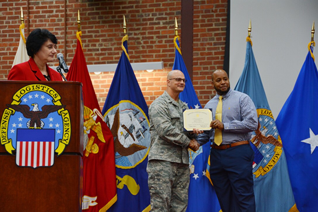 Defense Logistics Agency Aviation Pathways to Career Excellence Program graduate, Albert Dorsey, receives his certificate from Defense Logistics Agency Aviation Commander Air Force Brig. Gen. Allan Day during a ceremony March 30, 2017 on Defense Supply Center Richmond, Virginia. Also pictured is Pam Latker, chief, DLA Human Resources Services, DLA Training Career Management Division.