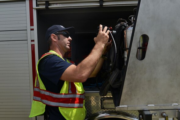 Heath Griffin, Sumter Fire Department master firefighter, stores air cylinders inside a fire truck in Sumter, S.C., March 30, 2017. The Sumter Fire Department was one of the responding agencies during a major accident response exercise that tested the readiness of community responders. (U.S. Air Force photo by Airman 1st Class Destinee Sweeney)