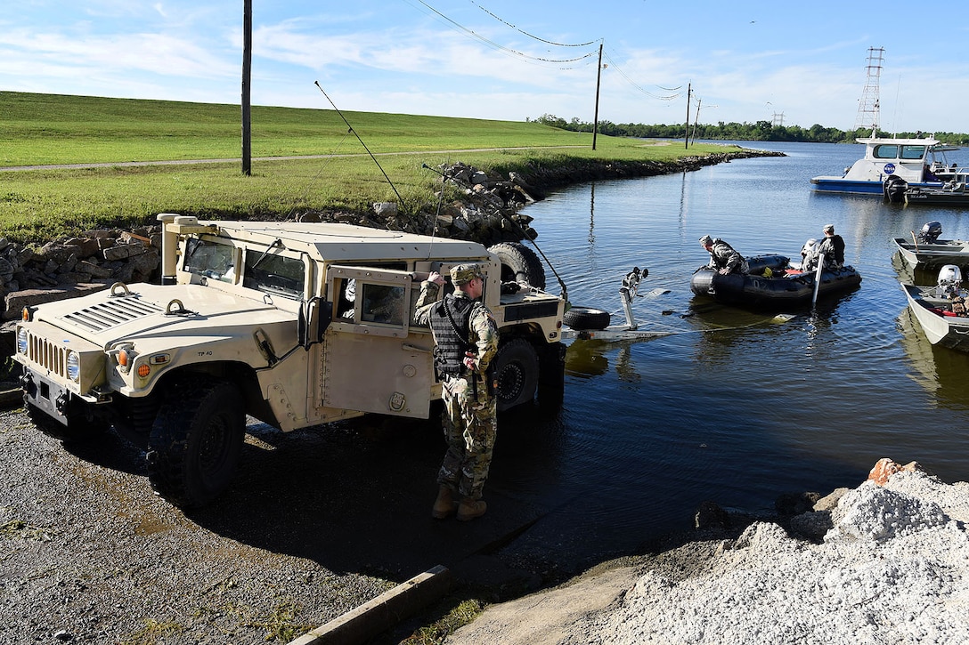 Louisiana Army National Guard members launch a Zodiac boat before participating in a disaster relief exercise at Michoud Assembly Facility in New Orleans, Louisiana, April 1, 2017. The soldiers are assigned to the Louisiana Army National Guard’s C Troop 108th Cavalry Squadron. Army National Guard photo by Spc. Garrett L. Dipuma