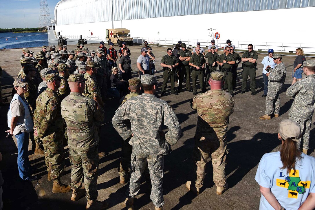 Louisiana Army National Guard members and a group from the Louisiana Wildlife and Fisheries and Louisiana State Animal Response Team receive a safety brief before participating in water rescue training during a disaster relief exercise at Michoud Assembly Facility in New Orleans, Louisiana, April 1, 2017. Army National Guard photo by Spc. Garrett L. Dipuma