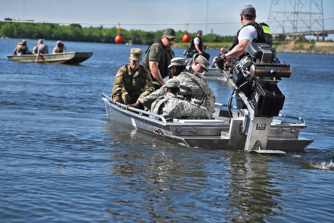 Louisiana Army National Guard members and a group from Wildlife and Fisheries participate in water rescue training during a disaster relief exercise at Michoud Assembly Facility in New Orleans, Louisiana, April 1, 2017. Army National Guard photo by Spc. Garrett L. Dipuma