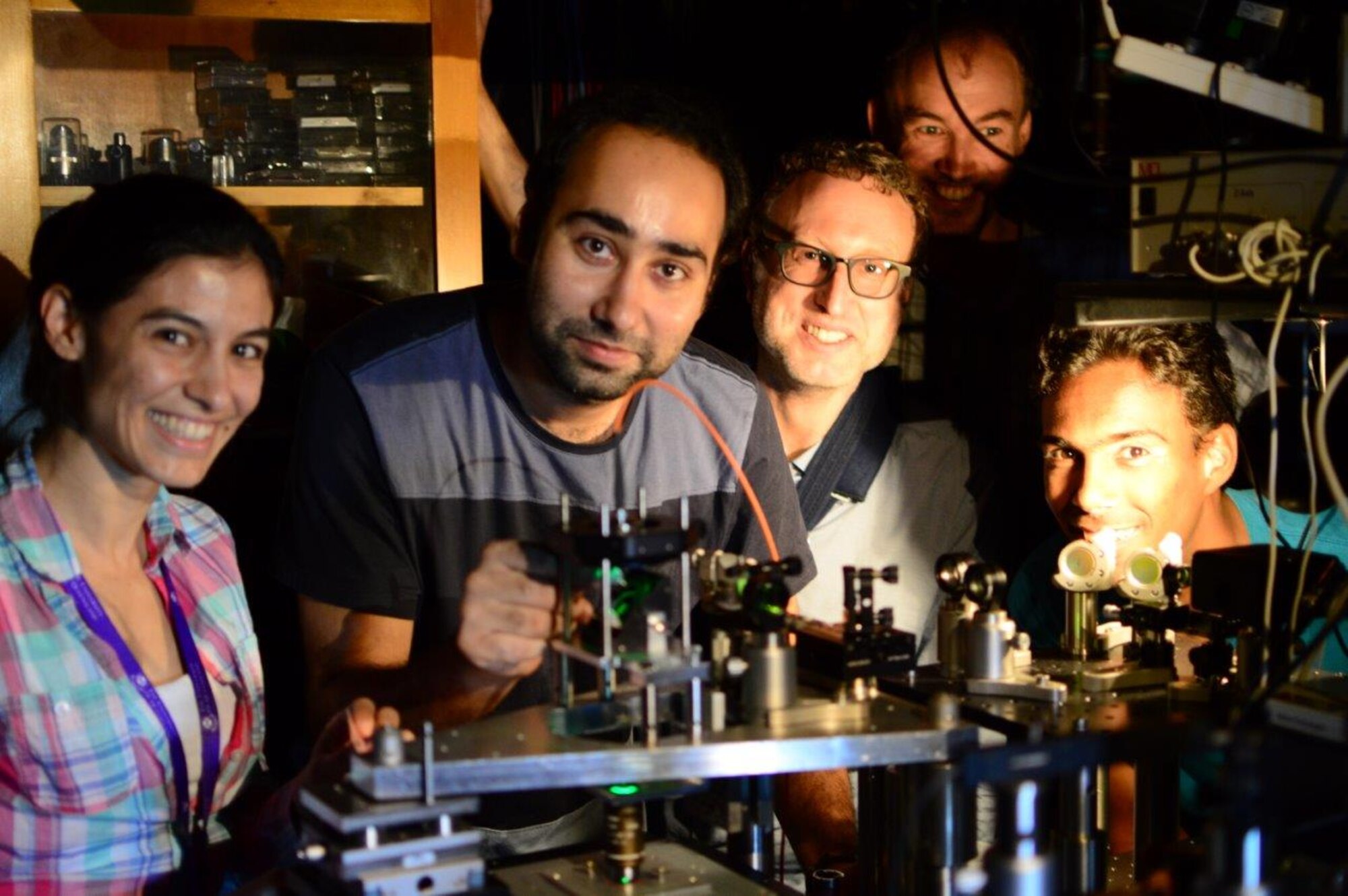 Researchers Catxere Casacio, Waleed Muhammad, Warwick Bowen, Lars Madsen, and Nicholas Mauranyapin perform quantum optics experiments at the Laboratory for Translational Quantum Science, in the Australian Centre for Engineered Quantum Systems, University of Queensland on November 30, 2016. The experiments are being performed broadly to bring to bear techniques from quantum optics on the biological sciences and microscopy, with the goal of enhancing the resolution and speed of biological imaging and sensing.   (Courtesy photo / Erick Romero)