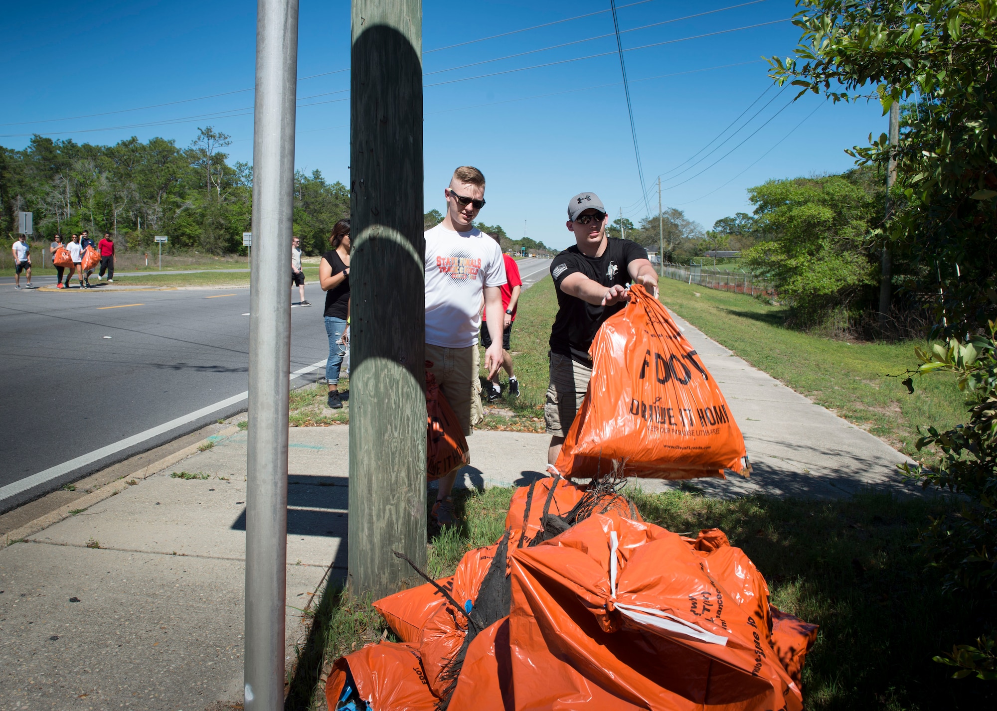 Air Commandos with the 1st Special Operations Support Squadron collect trash during a highway-cleanup event in Fort Walton Beach, Fla., March 31, 2017. The Air Commandos with the 1st SOSS cover a 2.4-mile stretch of highway quarterly picking up trash in an effort to help keep Florida beautiful.  (U.S. Air Force photo by Senior Airman Krystal M. Garrett) 