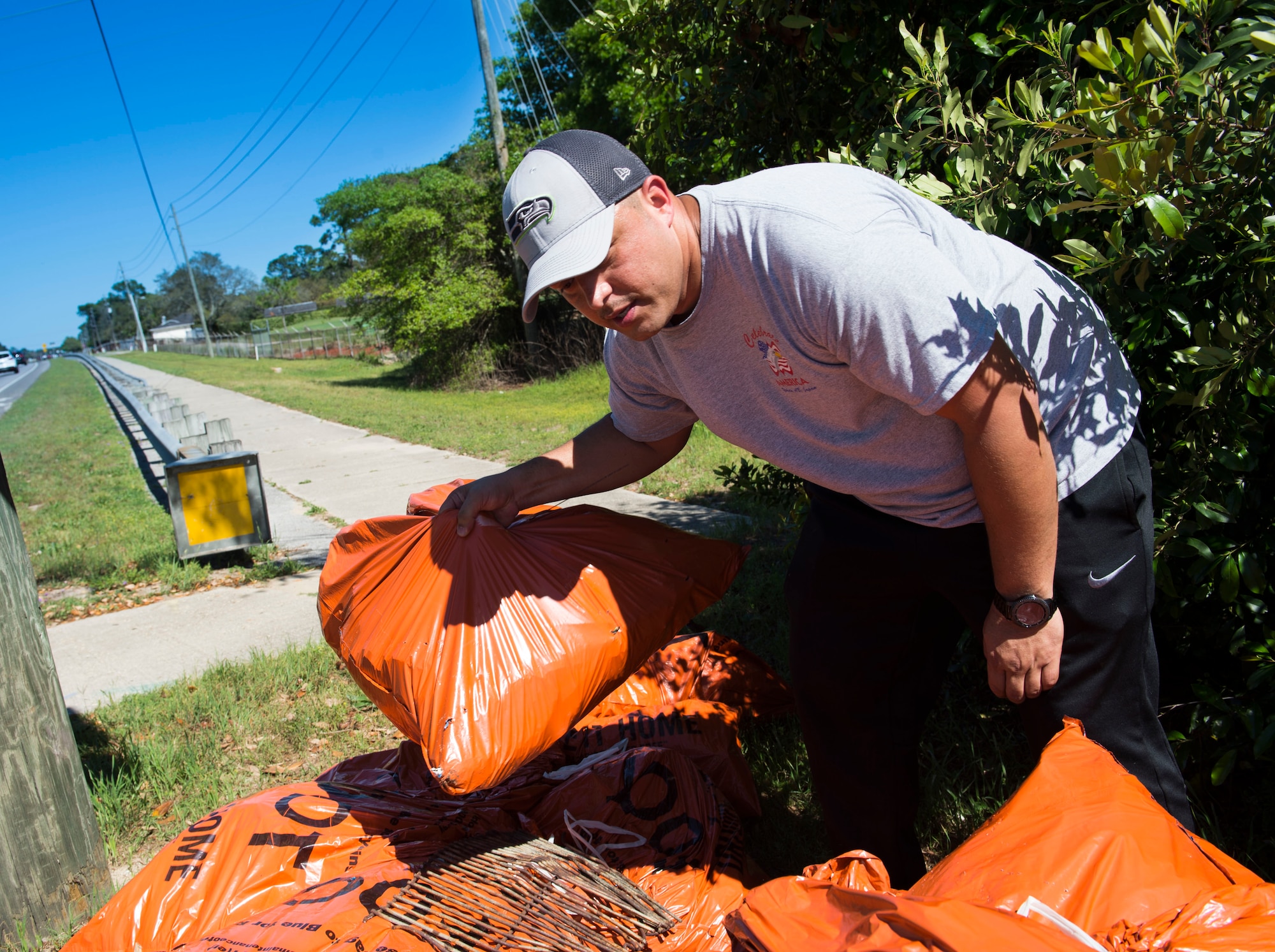 Tech Sgt. Jose Augilar, the chief of aircrew flight equipment flight with the 1st Special Operations Support Squadron, collects trash bags after a highway-cleanup event in Fort Walton Beach, Fla., March 31, 2017. Air Commandos with the 1st SOSS cover a 2.4-mile stretch of highway quarterly picking up trash in an effort to help keep Florida beautiful.  (U.S. Air Force photo by Senior Airman Krystal M. Garrett) 
