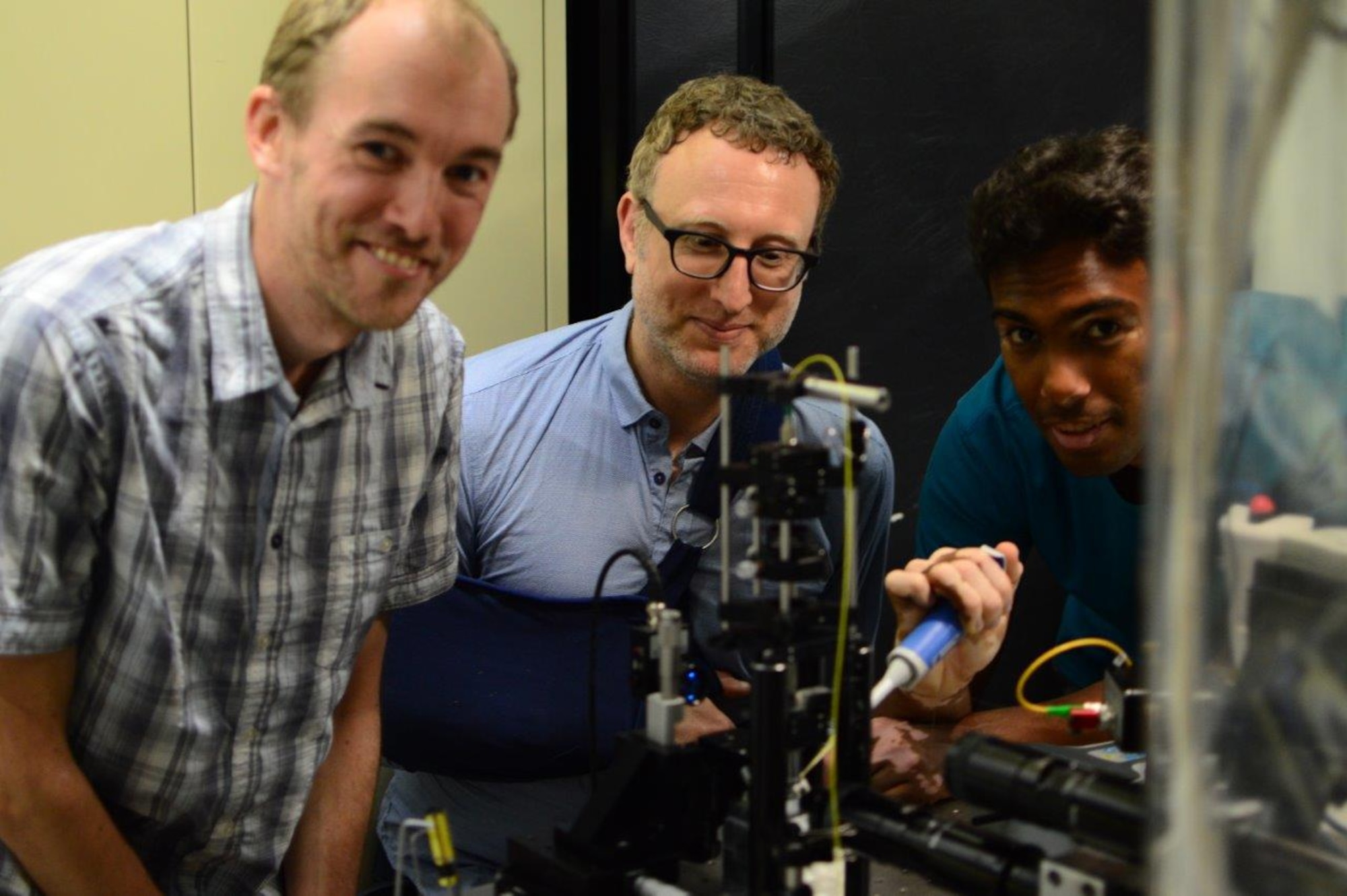 Researchers Lars Madsen, Warwick Bowen, and Nicholas Mauranyapin perform quantum optics experiments at the Laboratory for Translational Quantum Science, in the Australian Centre for Engineered Quantum Systems, University of Queensland on November 30, 2016. The experiments are being performed broadly to bring to bear techniques from quantum optics on the biological sciences and microscopy, with the goal of enhancing the resolution and speed of biological imaging and sensing. (Courtesy photo / Erick Romero)