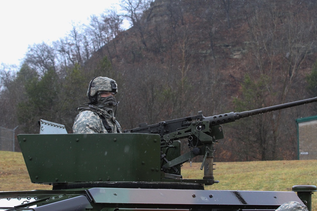 U.S. Army Reserve Sgt. Phillip McCaffrey, 238th Transportation Company (Improved Cargo Handling Operations), 79th Sustainment Support Command, waits in the rain for his turn to complete qualification live-fire during Operation Cold Steel at Fort McCoy, Wis., April 3, 2017. Operation Cold Steel is the U.S. Army Reserve's crew-served weapons qualification and validation exercise to ensure that America's Army Reserve units and Soldiers are trained and ready to deploy on short-notice and bring combat-ready and lethal firepower in support of the Army and our joint partners anywhere in the world. (U.S. Army Reserve photo by Staff Sgt. Debralee Best, 84th Training Command)