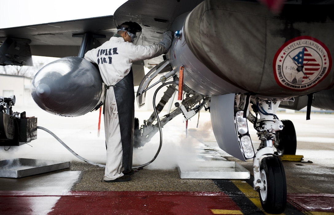 An Airman with the 113th Maintenance Squadron fills an F-16 Fighting Falcon with liquid oxygen at Joint Base Andrews, Md., March 27, 2017. Liquid oxygen is used to provide oxygen to pilots when they are above 10,000 feet, during flight. (U.S. Air Force photo by Airman 1st Class Gabrielle Spalding)
