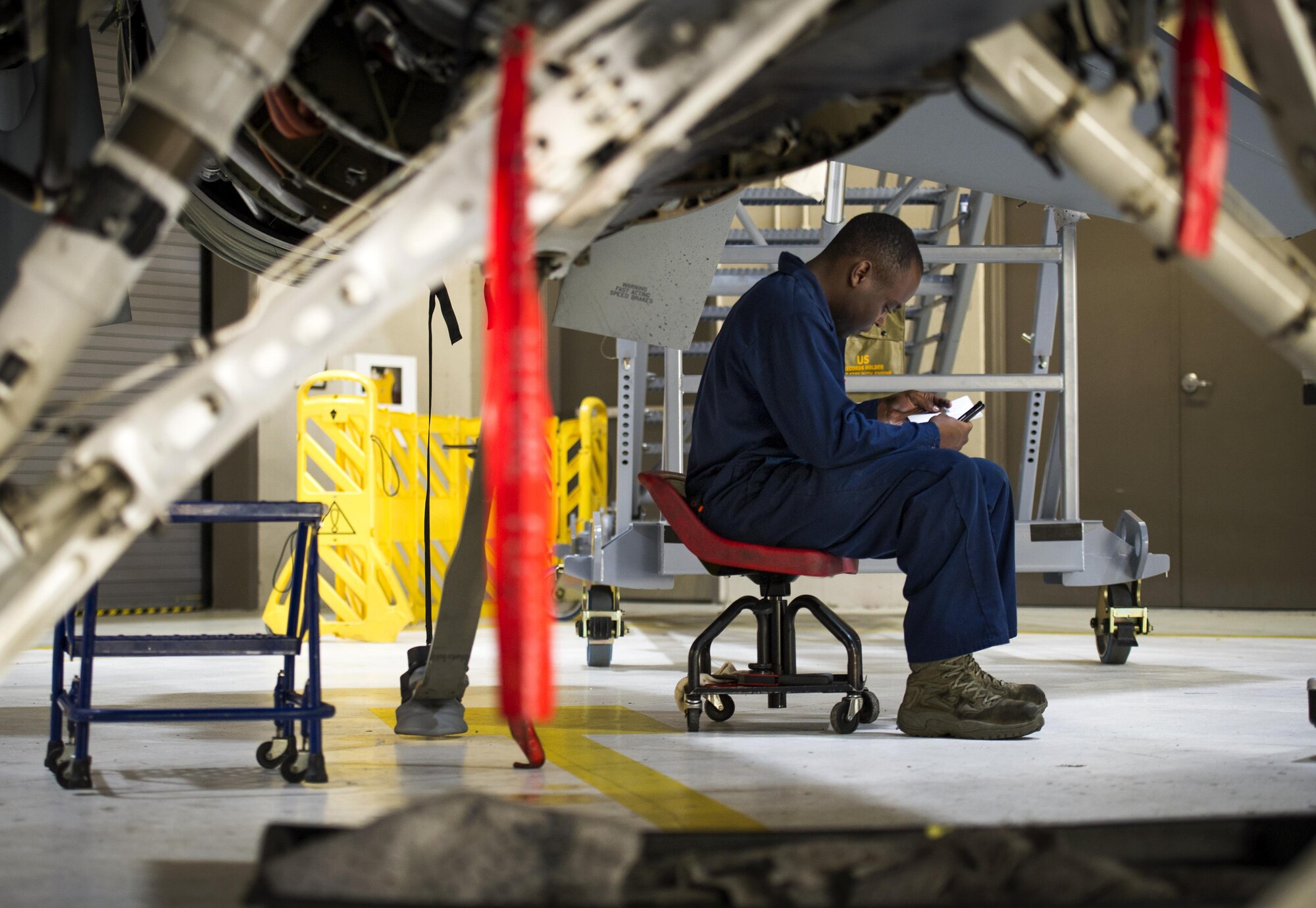 A 113th Wing maintenance technician logs information during an inspection of an F-16 Fighting Falcon at Joint Base Andrews, Md., March 27, 2017. Aircraft Inspections are conducted to ensure the F-16’s are prepared to support the 113th WG’s 24/7 alert fighter defense mission to the National Capital Region. (U.S. Air Force photo by Airman 1st Class Gabrielle Spalding)