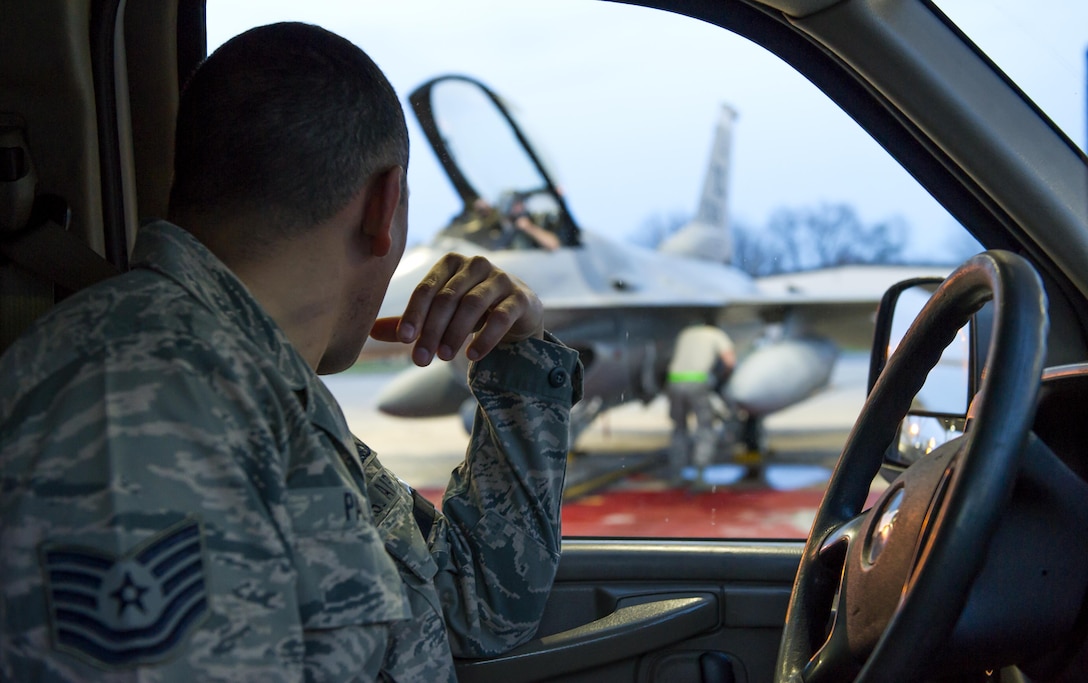 Tech. Sgt. Alberto Padilla, 113th Maintenance Squadron flightline expediter, oversees a maintenance Airman working on an F-16 Fighting Falcon at Joint Base Andrews, Md., March 27, 2017. As a flightline expediter, Padilla must accurately manage, control and direct resources to accomplish maintenance needs. He also reports to the production superintendent so they can accurately determine things like aircraft availability. (U.S. Air Force photo by Airman 1st Class Gabrielle Spalding)