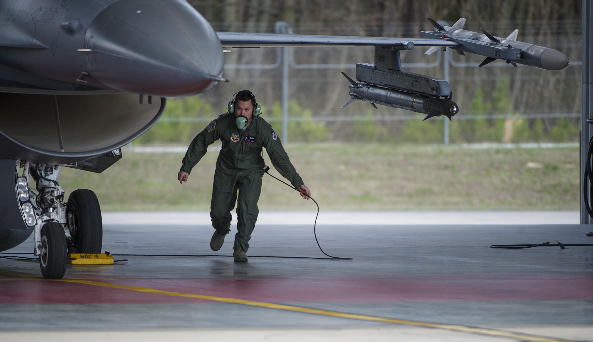 Staff Sgt. Kyle Adams, 113th Aerospace Control Alert crew chief, performs a pre-flight inspection on an F-16 Fighting Falcon during an alert scramble at Joint Base Andrews, Md., March 28, 2017. An alert scramble is a rapid response to any air defense operation and air emergency. The 113th ACA facility has more than double the number of alert events than all other active duty and National Guard bases combined. (U.S. Air Force photo by Airman 1st Class Gabrielle Spalding)