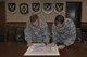 Chief Master Sgt. John Storms, 93d Air Ground Operations Wing command chief, left, and Col. Bradley Smith, 93d AGOW vice commander, sign a proclamation, March 20, 2017, at Moody Air Force Base, Ga. The proclamation was signed to declare the month of April 2017 as Sexual Assault Prevention and Response month for Team Moody. This year’s theme for SAPR month is “Protecting our people protects our mission.” (U.S. Air Force photo by Airman 1st Class Lauren M. Sprunk)