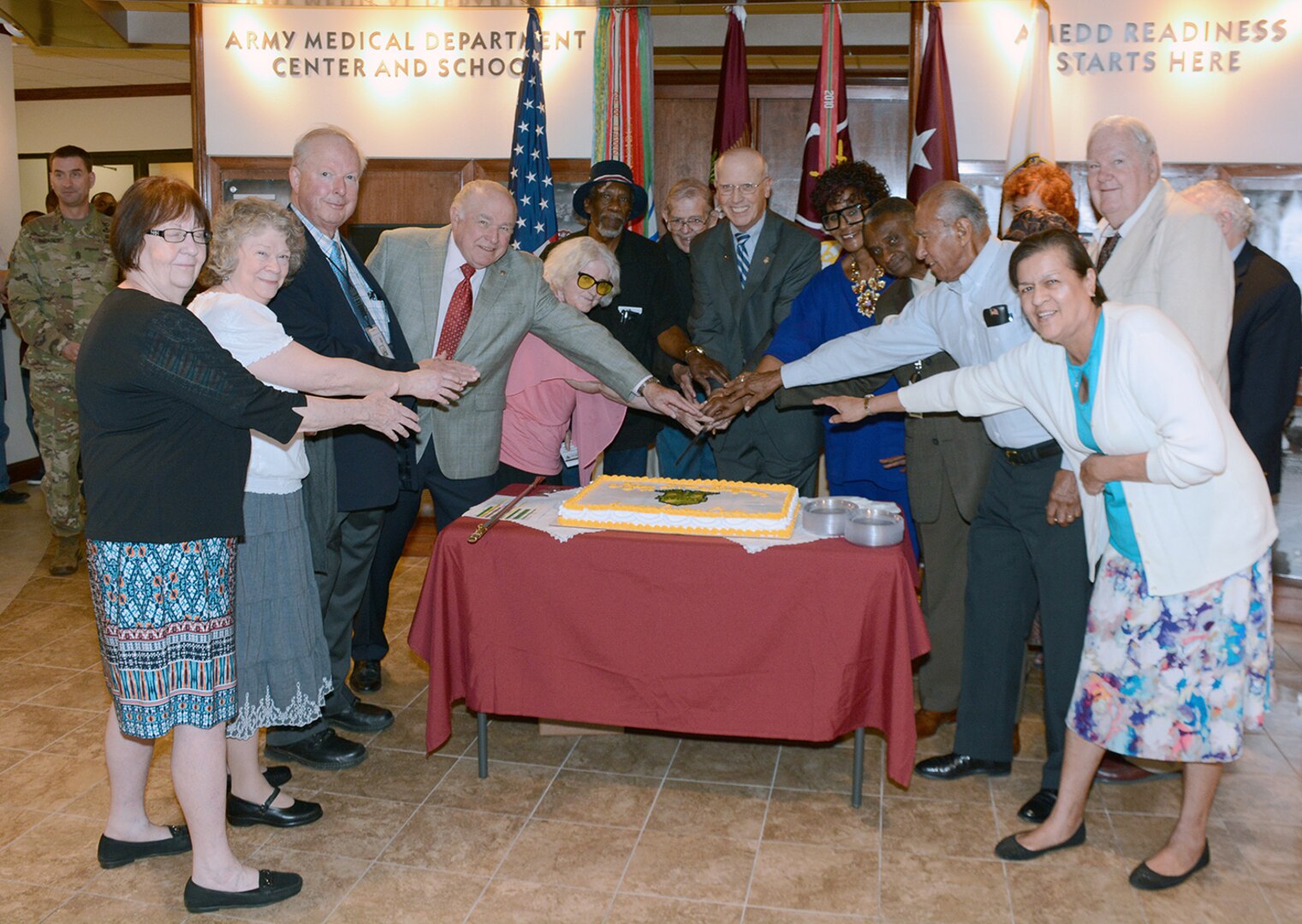 Charles G. (Gregg) Stevens, SES, Army Medicine Civilian Corps Chief, along with some of the longest serving members of the Civilian Corps, cut a cake celebrating the 21st anniversary of the corps. The Army Medical Department Civilian Corps was established on March 26, 1996.