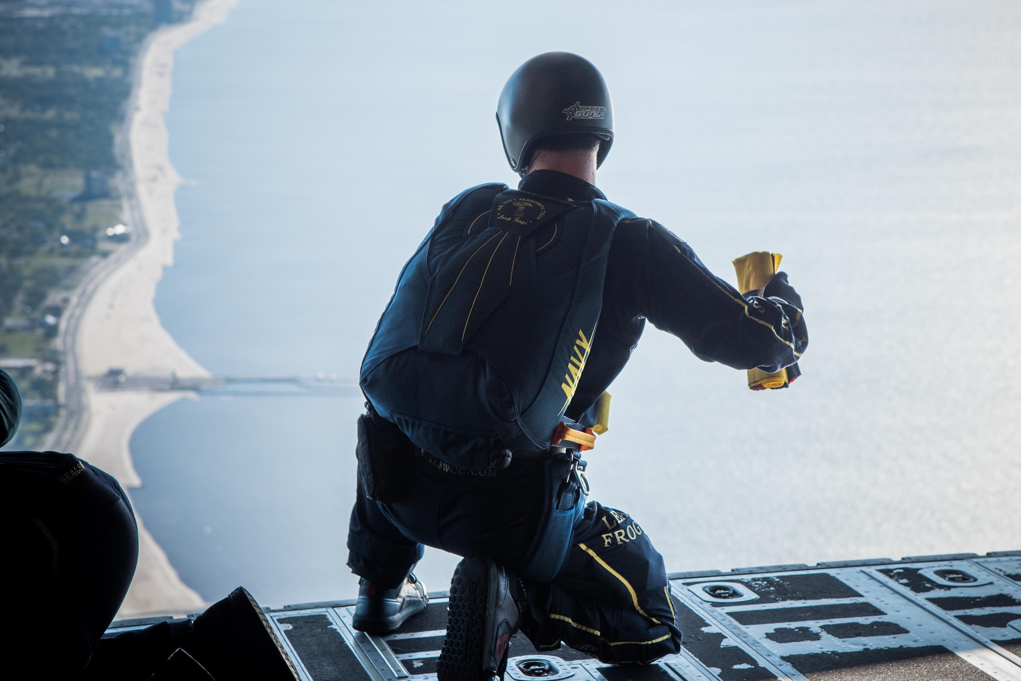A member of the U.S. Navy Leap Frogs checks the landing conditions on the Gulf Coast on board an 815th Airlift Squadron C-130J Super Hercules aircraft April 4. The Leap Frogs coordinated with the Flying Jennies to complete this jump and several others out of Keesler Air Force Base, Mississippi as joint training for both groups, which was also in conjunction with Navy Week and the Mississippi bicentennial celebration. (U.S. Air Force photo/Staff Sgt. Heather Heiney)