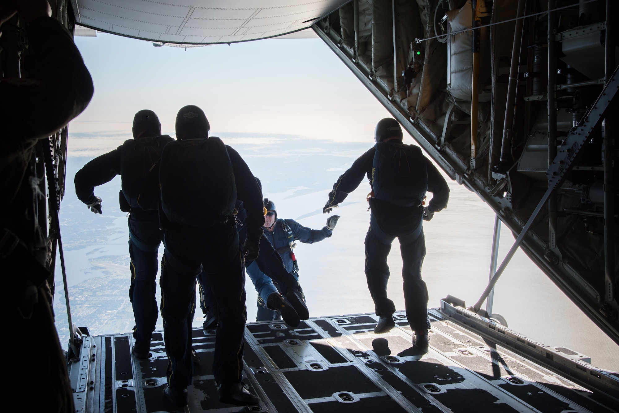 Members of the U.S. Navy Leap Frogs jump from an 815th Airlift Squadron C-130J Super Hercules aircraft  April 4. The Leap Frogs coordinated with the Flying Jennies to complete this jump and several others out of Keesler Air Force Base, Mississippi as joint training for both groups, which was also in conjunction with Navy Week and the Mississippi bicentennial celebration. (U.S. Air Force photo/Staff Sgt. Heather Heiney)