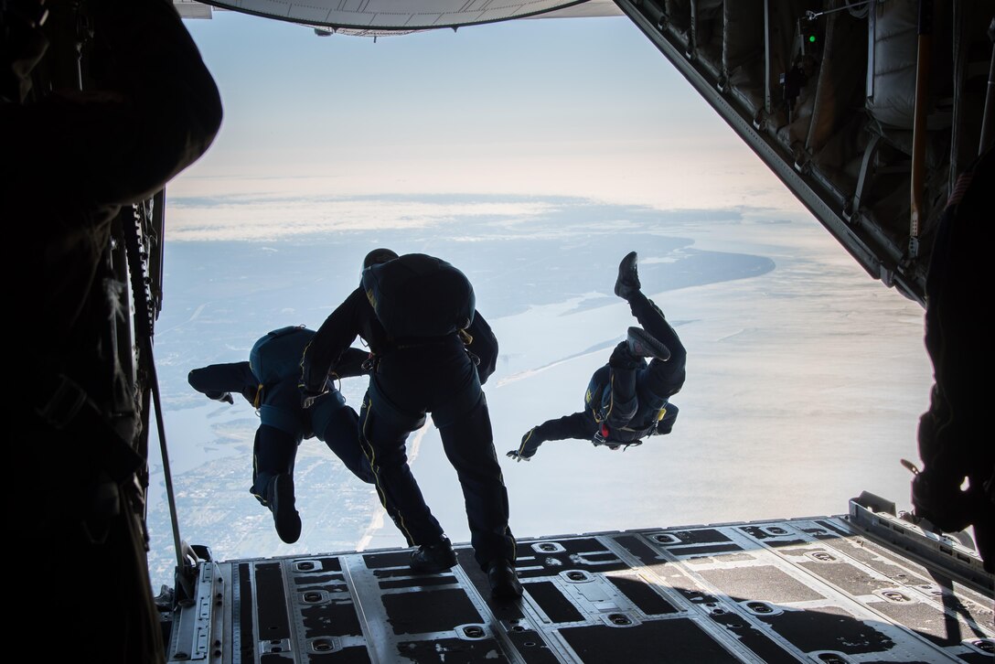 Members of the U.S. Navy Leap Frogs jump from an 815th Airlift Squadron C-130J Super Hercules aircraft  April 4. The Leap Frogs coordinated with the Flying Jennies to complete this jump and several others out of Keesler Air Force Base, Mississippi as joint training for both groups, which was also in conjunction with Navy Week and the Mississippi bicentennial celebration.  (U.S. Air Force photo/Staff Sgt. Heather Heiney)