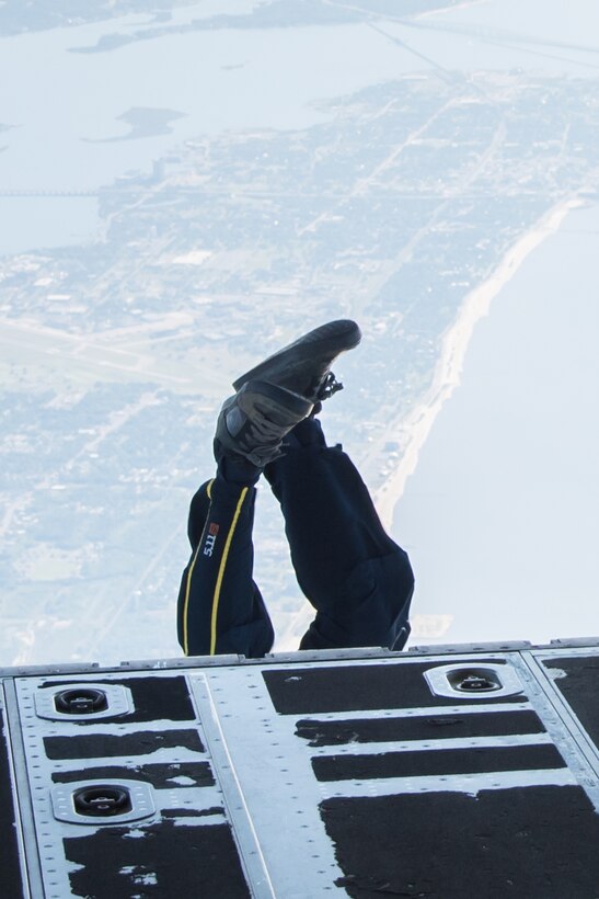 A member of the U.S. Navy Leap Frogs jumps from an 815th Airlift Squadron C-130J Super Hercules aircraft  April 4. The Leap Frogs coordinated with the Flying Jennies to complete this jump and several others out of Keesler Air Force Base, Mississippi as joint training for both groups, which was also in conjunction with Navy Week and the Mississippi bicentennial celebration. (U.S. Air Force photo/Staff Sgt. Heather Heiney)