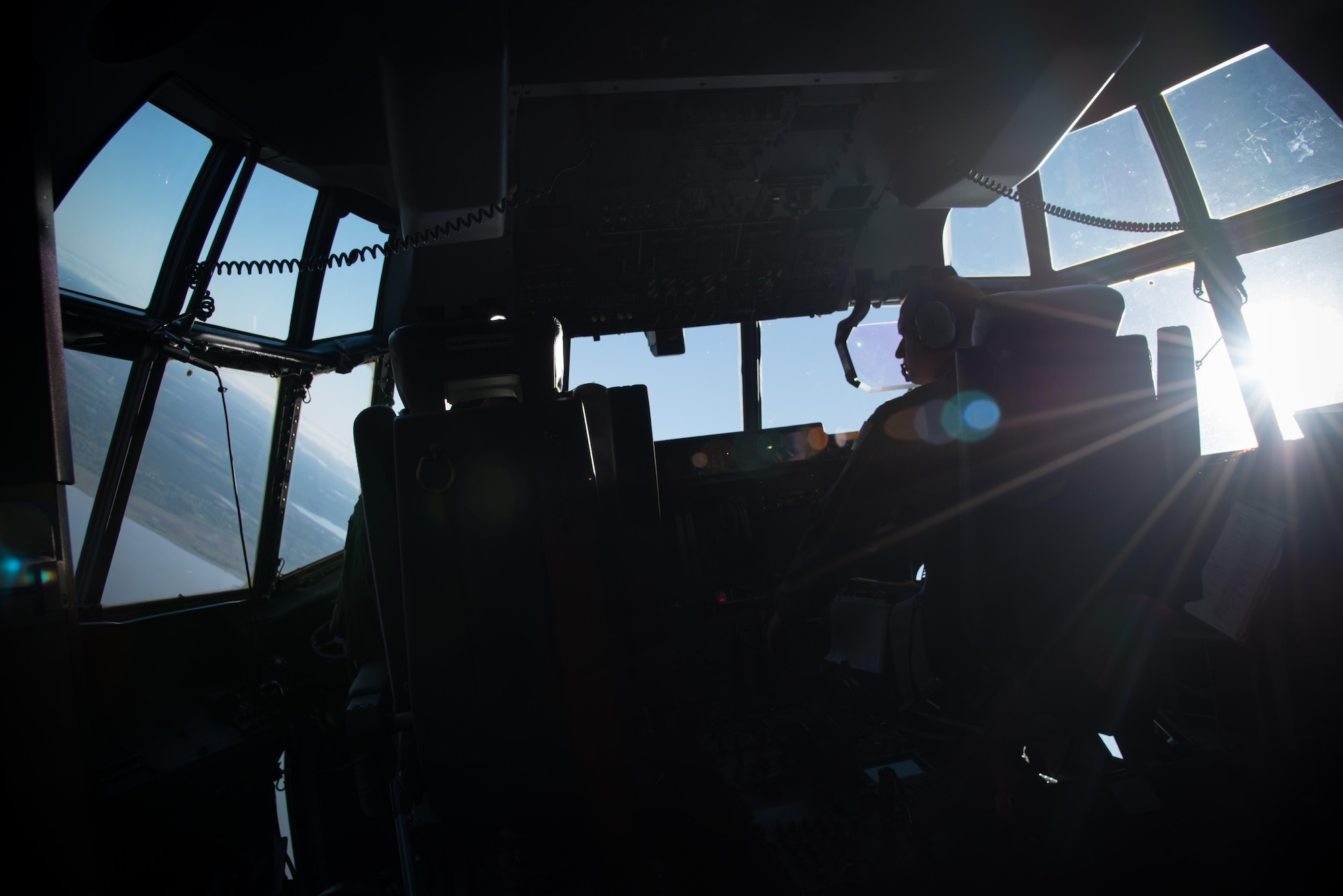 Capt. Nick Foreman and Capt. Jason Rimmer, 815th Airlift Squadron pilots, fly a C-130J Super Hercules aircraft April 4 during a jump mission with the U.S. Navy Leap Frogs. The Leap Frogs coordinated with the Flying Jennies to complete this jump and several others out of Keesler Air Force Base, Mississippi as joint training for both groups, which was also in conjunction with Navy Week and the Mississippi bicentennial celebration.  (U.S. Air Force photo/Staff Sgt. Heather Heiney)