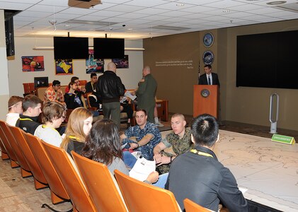 U.S. Navy Lt. Nicholas Preston (seated left), assigned to U.S. Strategic Command’s (USSTRATCOM) capability and resource integration directive, and U.S. Marine Corps Capt. Scott Johnsonmartin (seated right), assigned to USSTRATCOM global operations directorate, leads students from Ralston High School through a simulated scenario in the wargame center during their visit to Offutt Air Force Base, Neb., April 3, 2017, as part of the Greater Omaha Chamber of Commerce Careerockit program. During the visit, students received a command mission briefing, and toured USSTRATCOM’s Global Operations Center. Careerockit, which is supported by other community partners including USSTRATCOM, connects the area’s business and educational community and provides learning and career opportunities for local students and young adults. One of nine Department of Defense unified combatant commands, USSTRATCOM has global strategic missions assigned through the Unified Command Plan that include strategic deterrence; space operations; cyberspace operations; joint electronic warfare; global strike; missile defense; intelligence, surveillance and reconnaissance; and analysis and targeting. 