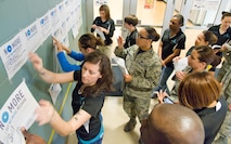 Team Dover Volunteer Victim Advocates place campaign posters on the graffiti wall during the Sexual Assault Awareness Month kickoff event March 31, 2017 at the Fitness Center on Dover Air Force Base, Del. The base has 27 Volunteer Victim Advocates, both male and female available to help 24 hours a day, seven days a week. (U.S. Air Force photo by Roland Balik)
