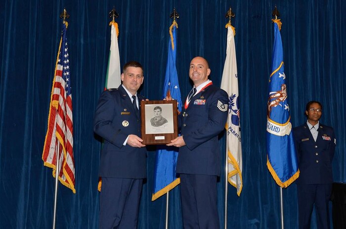 U.S. Air Force Tech. Sgt. Paul Woody, 437th Aircraft Maintenance Squadron, right, receives the John L. Levitow award for the McGhee Tyson NCO Academy class 17-2 from Col. Kevin Donovan, commander, left, at the I.G. Brown Training and Education Center in Louisville, Tennessee, Feb. 8, 2017. The John L. Levitow Award, the highest award for enlisted professional military education in the Air Force, is presented to the student who demonstrates the most outstanding leadership and scholastic achievement in Airman Leadership School, the NCOA and the Senior NCOA.  