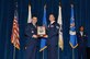 U.S. Air Force Tech. Sgt. Paul Woody, 437th Aircraft Maintenance Squadron, right, receives the John L. Levitow award for the McGhee Tyson NCO Academy class 17-2 from Col. Kevin Donovan, commander, left, at the I.G. Brown Training and Education Center in Louisville, Tennessee, Feb. 8, 2017. The John L. Levitow Award, the highest award for enlisted professional military education in the Air Force, is presented to the student who demonstrates the most outstanding leadership and scholastic achievement in Airman Leadership School, the NCOA and the Senior NCOA.  