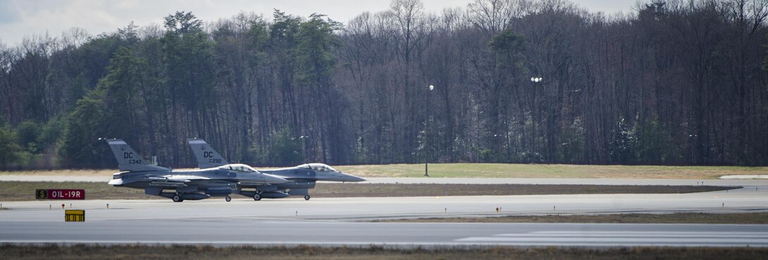 Two F-16 Fighting Falcon's wait to take off during an alert scramble at Joint Base Andrews, Md., March 28, 2017. A scramble is a rapid response to any air defense operation and air emergency. The 113th Aerospace Control Alert facility has more than double the number of alert events than all other active duty and National Guard bases combined. (U.S. Air Force photo by Airman 1st Class Gabrielle Spalding)