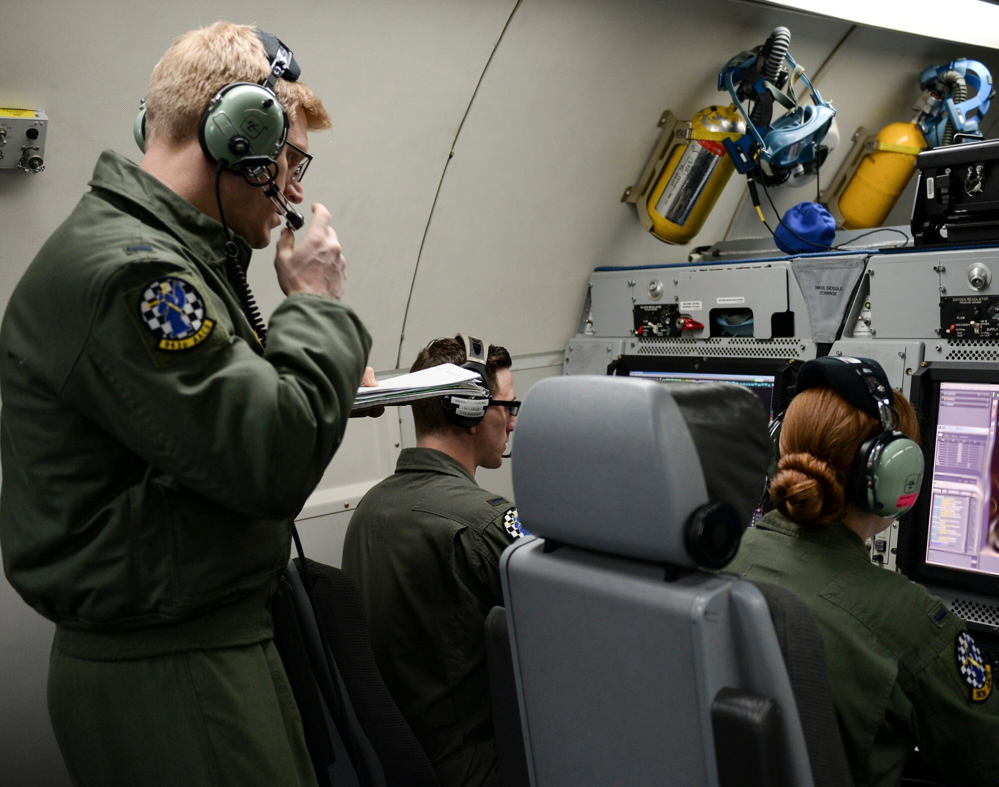 Members of the 963rd Airborne Air Control Squadron monitor air operations, March 15, while flying over the Pacific Northwest. The 963rd AACS is assigned to Tinker, and came to Mountain Home AFB to participate in the Gunfighter Flag exercise. (Air Force photo by Senior Airman Jessica H. Smith)