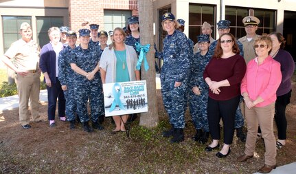 Naval Health Clinic Charleston Sexual Assault Prevention and Response representatives, NHCC command leadership and supporting staff members, tie a teal ribbon to a tree in front of NHCC, March 28, 2017, to kick off Sexual Assault Awareness and Prevention Month. This month offers an opportunity to build on existing momentum to eliminate sexual assault and ensure all servicemembers are in a work environment where they are treated with dignity and respect.