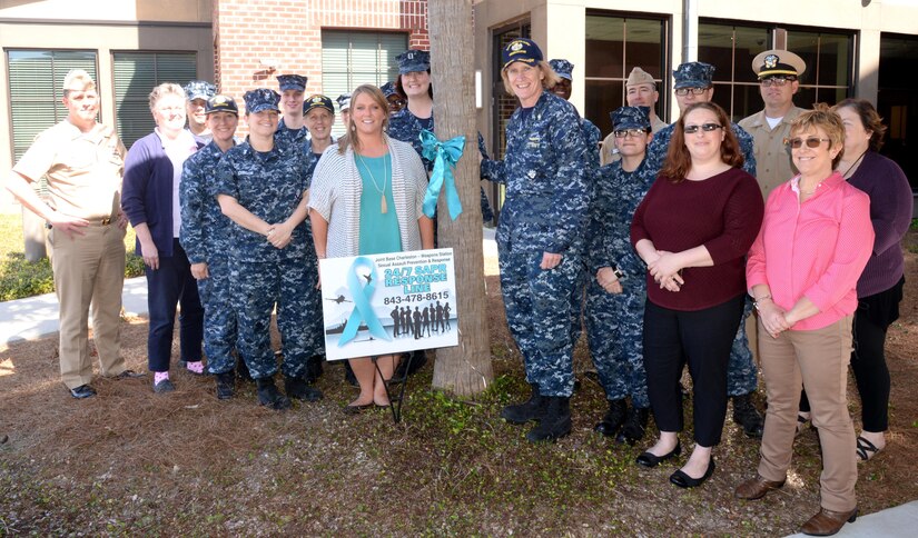 Naval Health Clinic Charleston Sexual Assault Prevention and Response representatives, NHCC command leadership and supporting staff members, tie a teal ribbon to a tree in front of NHCC, March 28, 2017, to kick off Sexual Assault Awareness and Prevention Month. This month offers an opportunity to build on existing momentum to eliminate sexual assault and ensure all servicemembers are in a work environment where they are treated with dignity and respect.