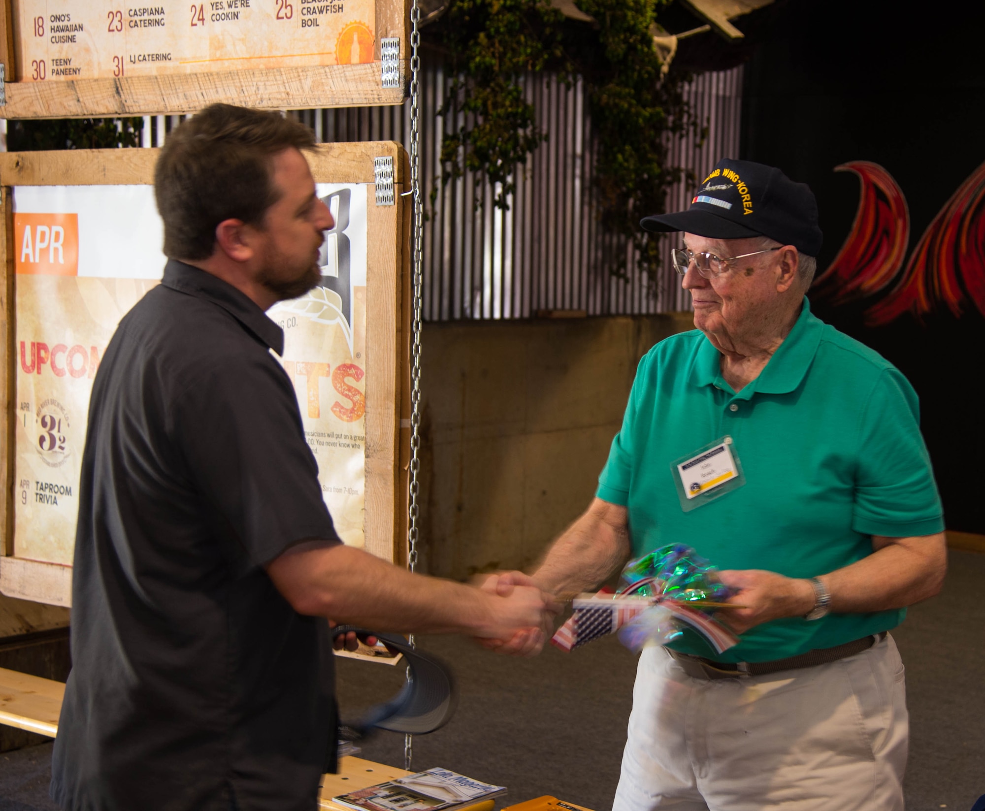 Jared Belville (left), Red River Brewing Co. managing partner, and John Roach (right), Korean War 307th Bombardment Group veteran, shakes hands during a tour of the Red River Brewing Co. in Shreveport, La., March 30, 2017. The 307th Bomb Wing celebrated their 75th Anniversary by taking alumni on a tour of Shreveport and Bossier City La, and hosting a gala to honor its bomber heritage. (U.S. Air Force photo by Staff Sgt. Jason McCasland/Released)