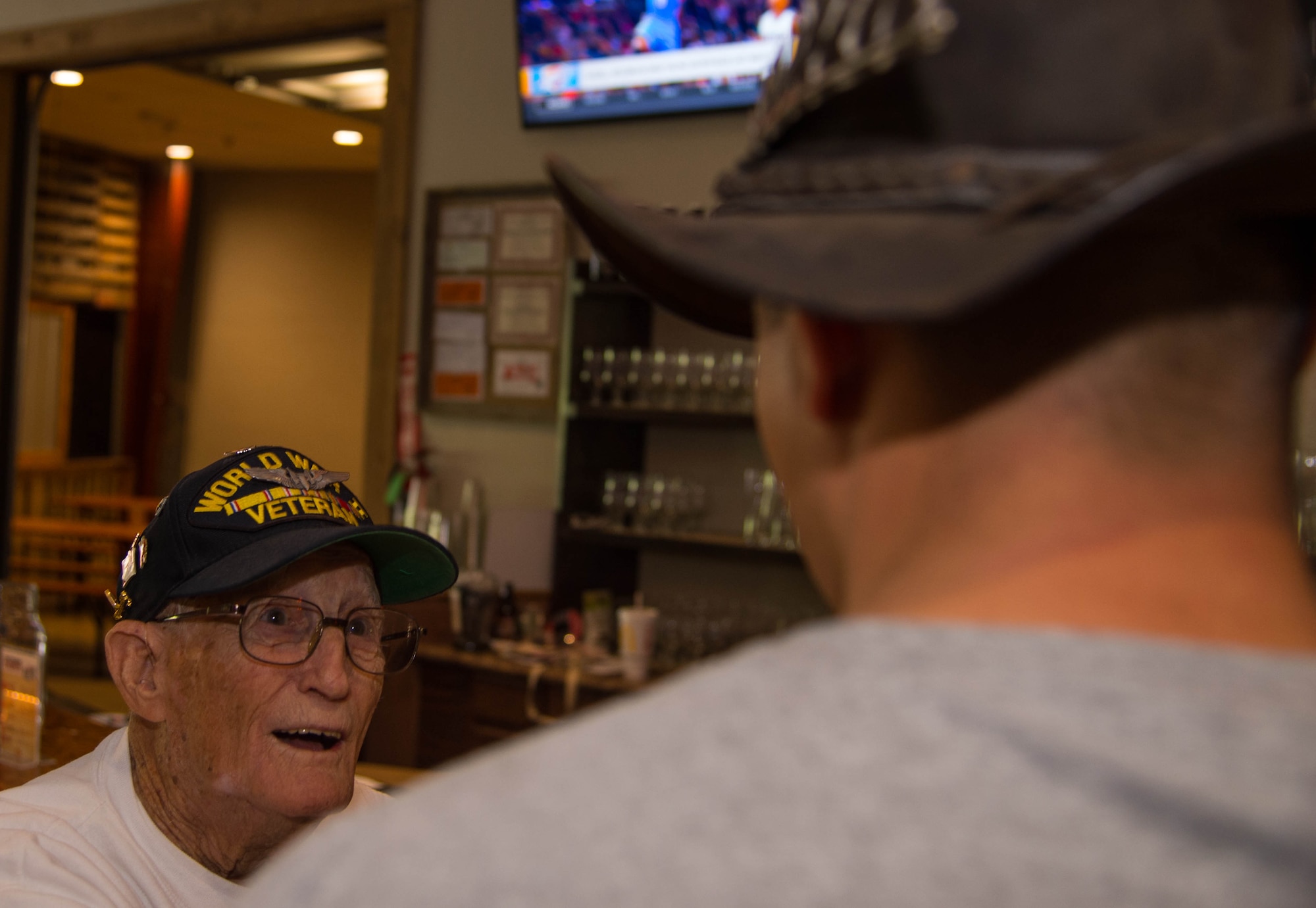 Dale Stickrath, World War II 307th Bombardment Group veteran, trades stories with another veteran at the Red River Brewing Co. Shreveport, La., March 30, 2017. In 1942, 27 B-24 Liberators from the 307th Bombardment Group took part in one of the longest mass-raids of that era which earned them the name “The Long Rangers.” The now, 307th Bomb Wing celebrated their 75th Anniversary with alumni from wars such as World War II, Korean War, Vietnam and Operation Inherent Resolve. (U.S. Air Force photo by Staff Sgt. Jason McCasland/Released)