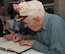 A 307th Bomb Wing alumni signs a book on the history of the 307th Bombardment Group during a reunion icebreaker event at the Shreveport Convention Center, Shreveport, La., March 30, 2017. The 307th BW hosted a reunion to celebrate the 75th anniversary of the unit and included alumni from wars such as World War II, the Korean War, Vietnam and the Cold War. (U.S. Air Force photo by Staff Sgt. Callie Ware/Released)