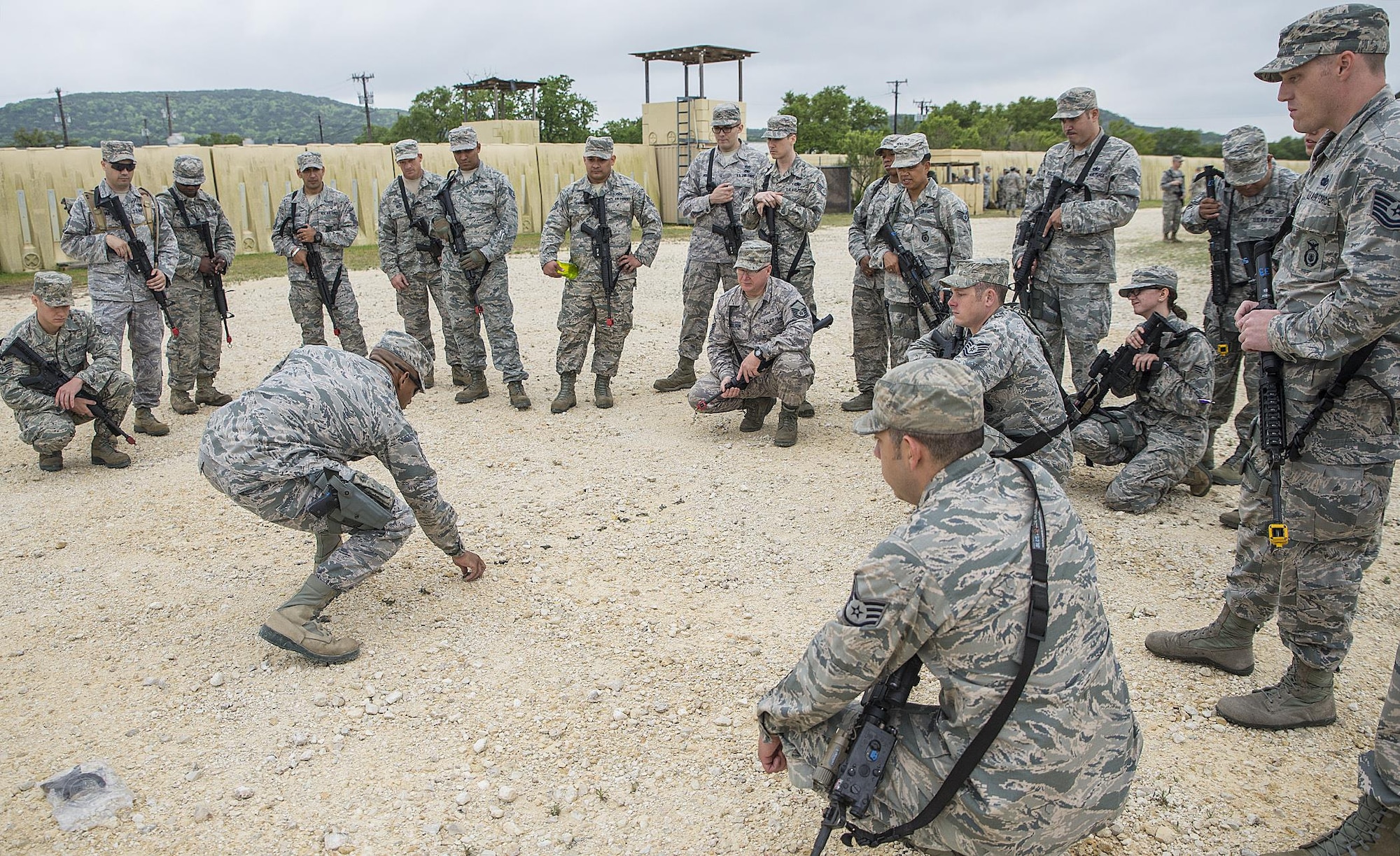 Tech.Sgt. Steven Cherry, 433rd Security Forces Squadron fire team leader, discusses tactical movement scenarios in the event of enemy contact at Training Base "Warrior" April 1, 2017 at Joint Base San Antonio-Camp Bullis, Texas. The 433rd SFS and 433rd Civil Engineer Squadron conducted a  six-block annual training regimen that included, application of force, tactics techniques and procedures, contingency patrol, movement, react to contact, and urban operations.  (U.S.  Air Force photo by Benjamin Faske)