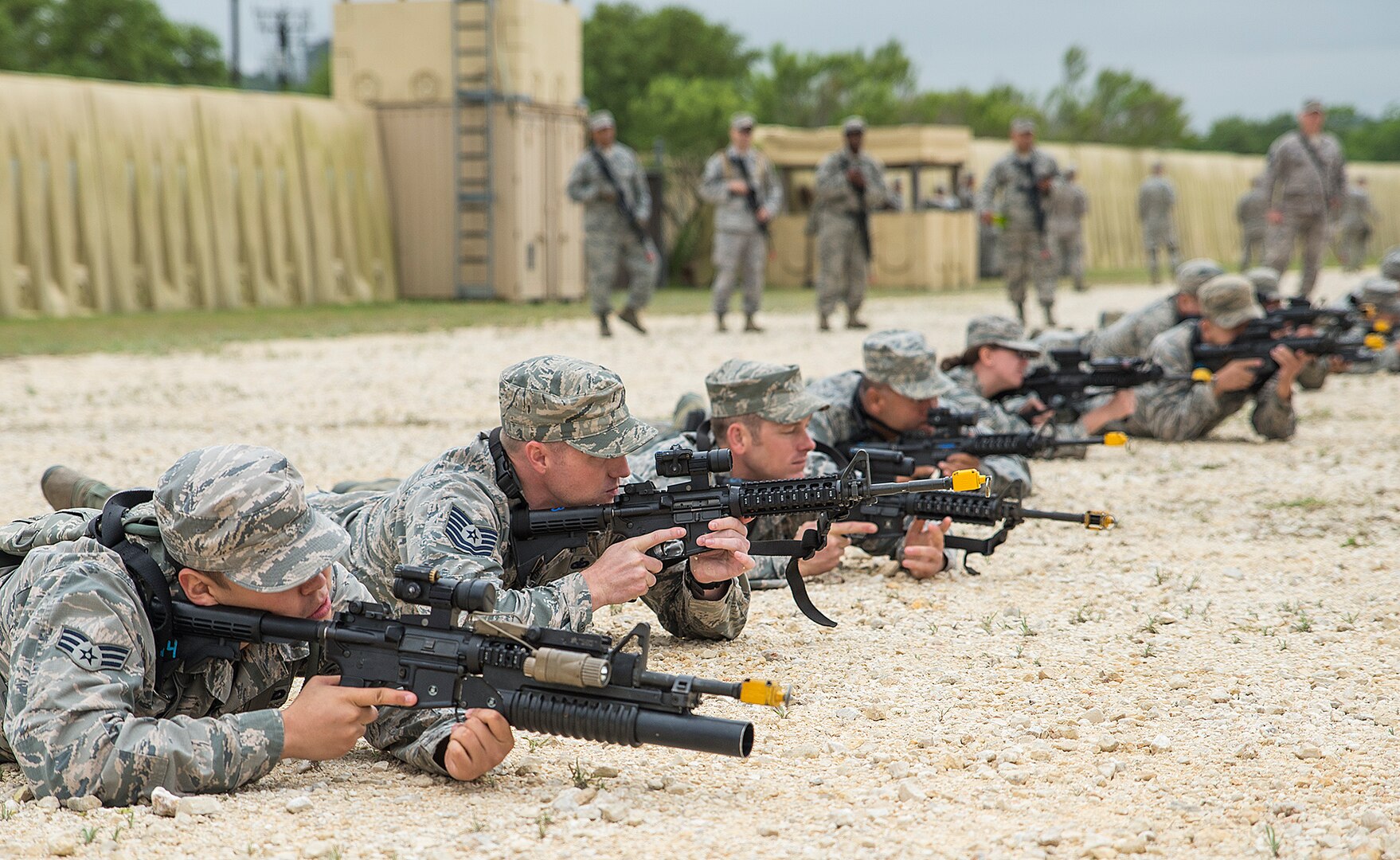 Airmen with the 433rd Security Forces and Civil Engineer Squadrons practice firing in formation during "Movement" training at Training Base "Warrior" April 1, 2017 at Joint Base San Antonio-Camp Bullis, Texas. The units conducted a  six-block annual training regimen that included, application of force, tactics techniques and procedures, contingency patrol, movement, react to contact, and urban operations.  (U.S.  Air Force photo by Benjamin Faske)