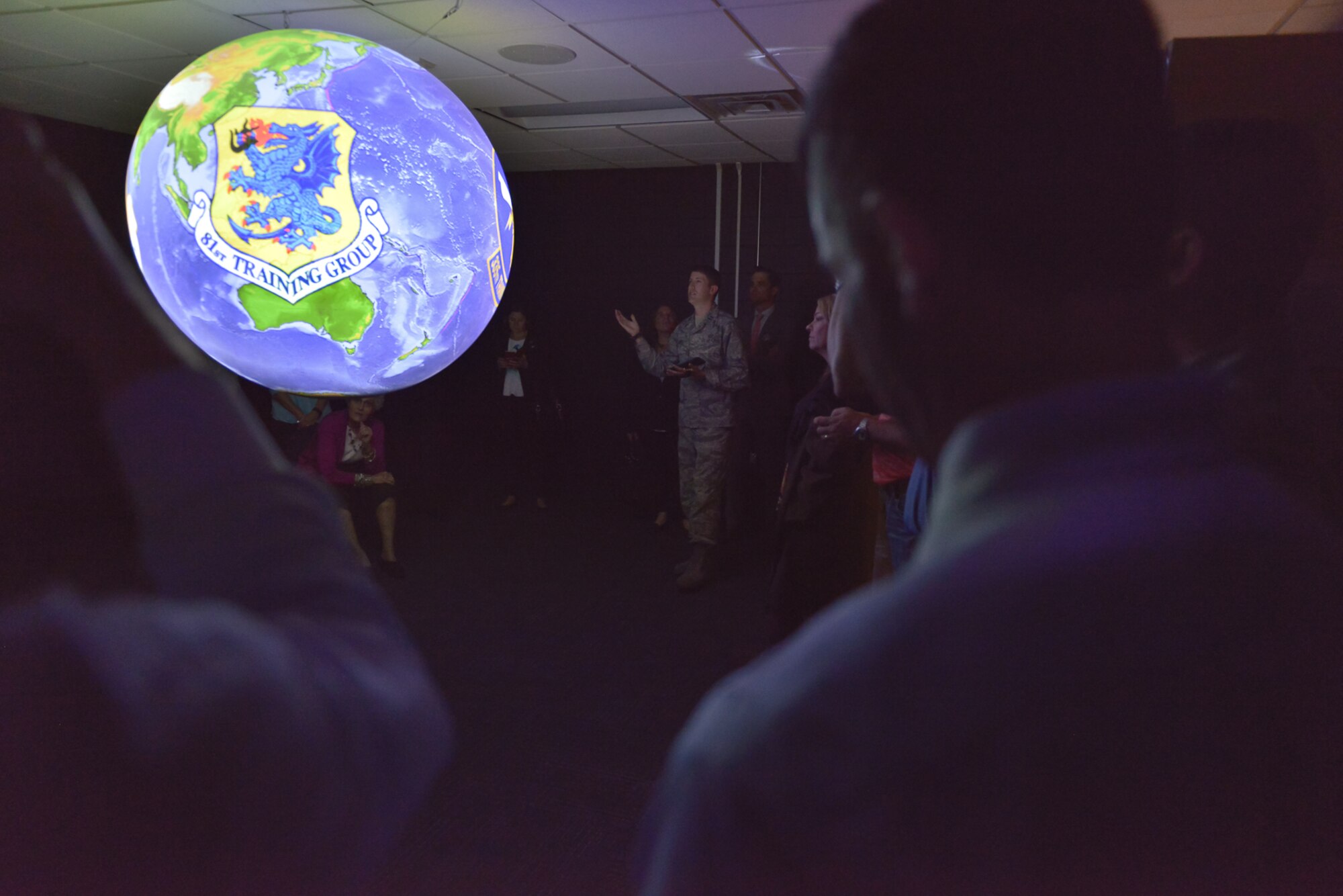 Capt. Caleb Tynes, 335th Training Squadron instructor supervisor, briefs 81st Training Wing honorary commanders on the Science on a Sphere planetary training aid at the Weather Training Complex, Mar. 30, 2017, on Keesler Air Force Base, Miss. The visit highlighted the training mission of the 81st Training Group for 81st TRW honorary commanders. (U.S. Air Force photo by Andre’ Askew)     